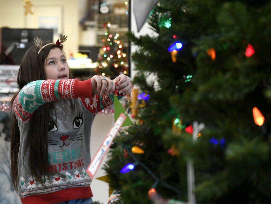 Children decorate town hall christmas tree